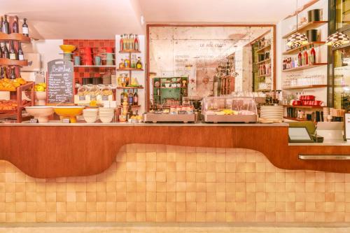 a counter in a store with bowls and dishes at Kraft Hotel in Paris