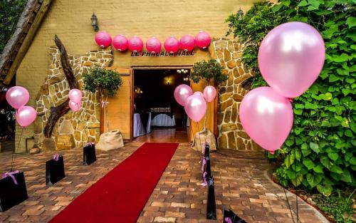 a bunch of pink balloons in front of a building at Bolivia Lodge in Polokwane