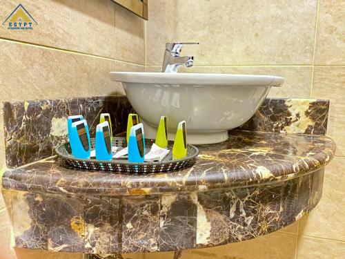 a bathroom with a sink and a counter with a sink at Egypt Pyramids Inn in Cairo