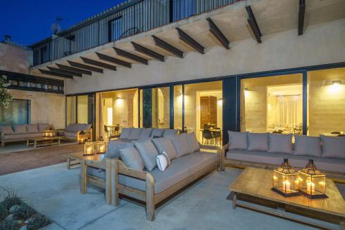 a living room with couches and a patio at Alqueria de Vilches in Cullera