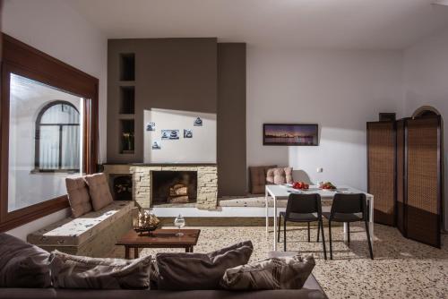 a living room with a couch and a table at Exclusive Seaside Retreat with Shared Pool & Private Beach Access in Palaiokastro