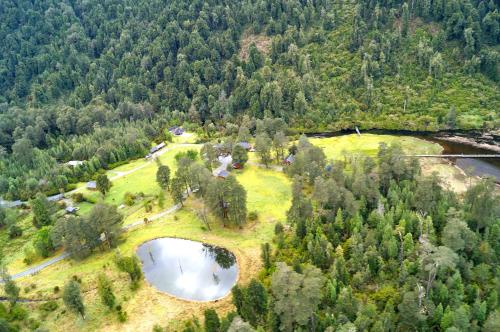 an aerial view of a park with two ponds and trees at El Pangue Lodge in Puerto Puyuhuapi