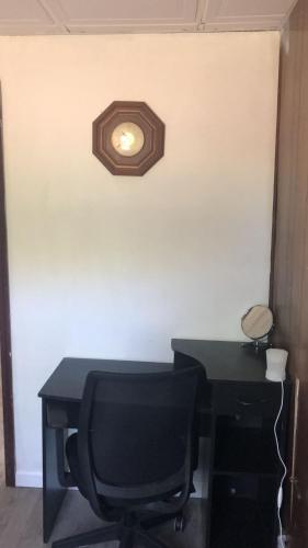 a desk with a chair and a light on a wall at room with a private shower in Arlington