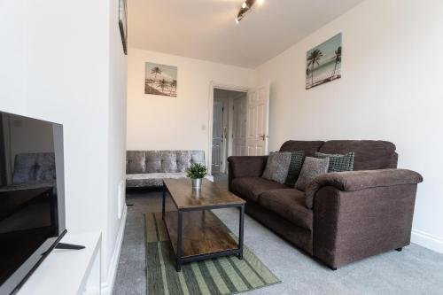 a living room with a couch and a coffee table at April Disc - Long Stay - Contractors in Bristol