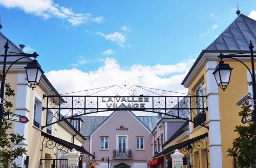a street sign in a town with buildings at Beautiful Apartment Disneyland in Saint-Thibault-des-Vignes
