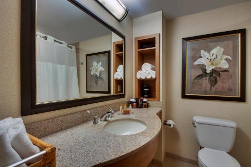a bathroom with a sink and a toilet and a mirror at Hollywood Casino Bangor in Bangor