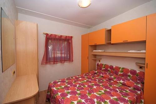 Letto o letti in una camera di Acquaviva Village Camping
