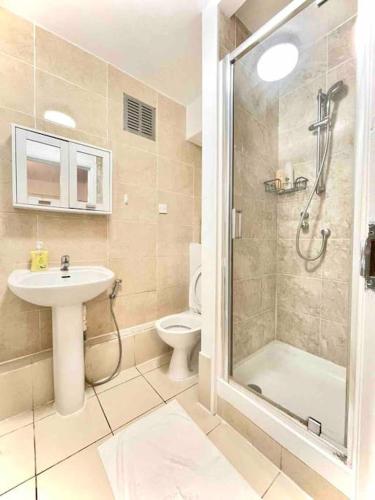 a bathroom with a shower and a sink and a toilet at Great Studio flat in Central London in London