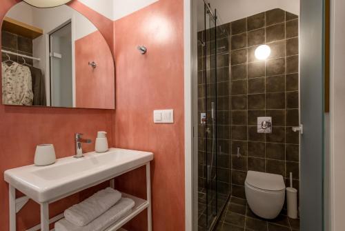 a bathroom with a sink and a toilet and a shower at Neratze Hammam Suites in Rethymno Town