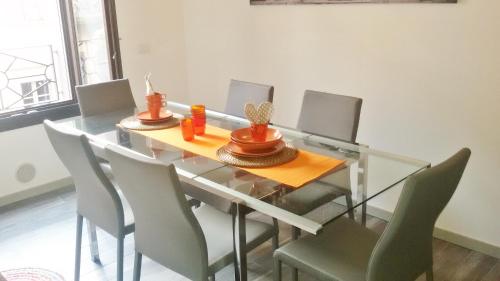 a dining room with a glass table and chairs at Como Via Carcano 13 in Como