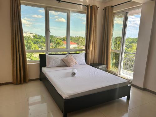 a bed in a room with a large window at Slipway Seaview in Dar es Salaam