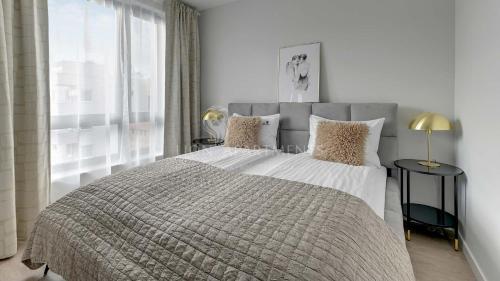 Ένα ή περισσότερα κρεβάτια σε δωμάτιο στο Lion Apartments - Neapol II Premium Apartments with Parking in the Center of Gdańsk