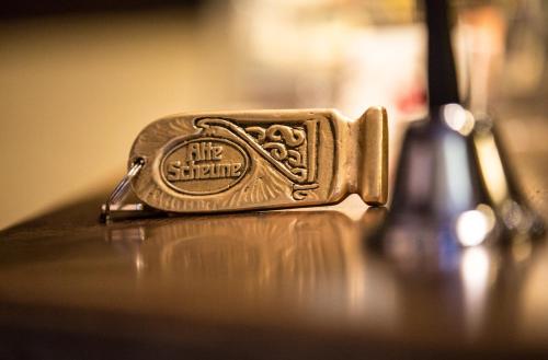a golden purse sitting on a table next to a bottle at Landhaus Alte Scheune in Frankfurt/Main