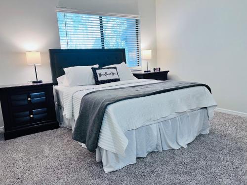 a bedroom with a large bed and two night stands at Urban Oasis Getaway in Jacksonville