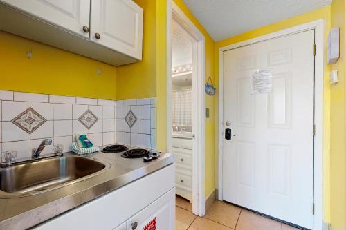a kitchen with a sink and a white door at Pirates Bay A210 in Fort Walton Beach
