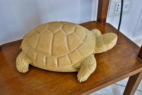 a stuffed turtle sitting on a wooden table at Holiday Home Castle Salemi - Casa Vacanze in Salemi