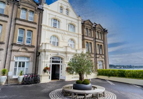 a building with a tree in front of it at Harbour Hotel Padstow in Padstow