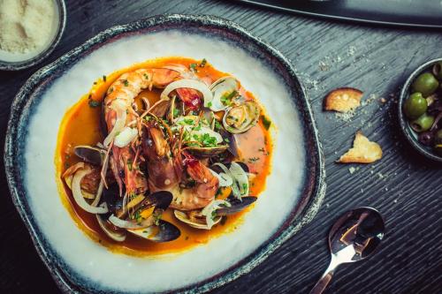 a plate of food with shrimp and vegetables on a table at Harbour Hotel Padstow in Padstow