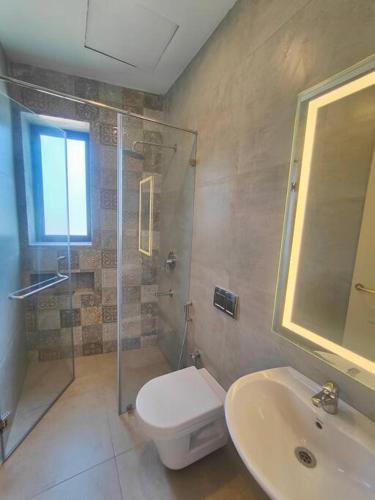 a bathroom with a toilet and a shower and a sink at Happy Home 3BHK Condo - Muttukadu ECR in Chennai