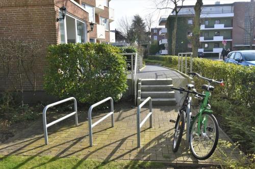 a bike parked on a sidewalk next to a building at Strandperle - 100m zum Strand in Scharbeutz