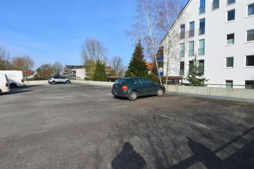 a car parked in a parking lot next to a building at Strandperle - 100m zum Strand in Scharbeutz