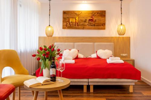 a bedroom with a red bed and a table with books at Ryterski in Rytro