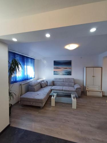 a living room with a couch and a table at Skajla Apartments in Medulin