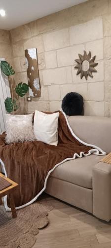 a bedroom with a couch and a brick wall at Palazzo Emy in Lecce