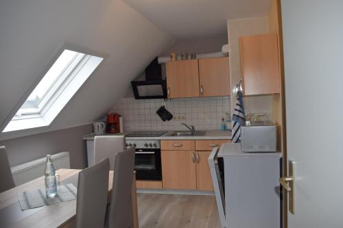 a kitchen with a sink and a stove top oven at Marktstübchen an der schönen Loreley in Bornich