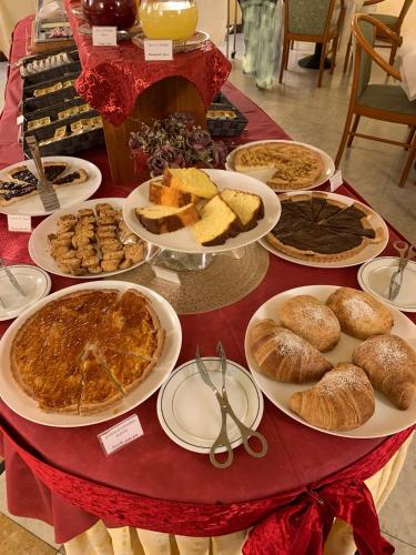a table topped with plates of food and bread at Savant Hotel in Lamezia Terme
