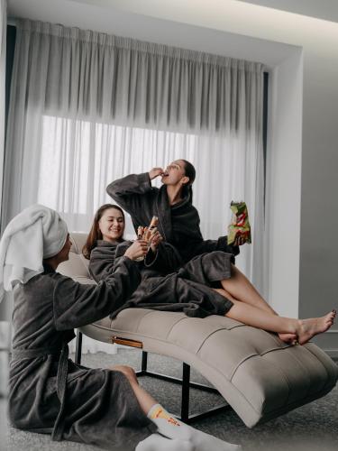 a group of people sitting on a couch at City Inn Lviv Smart Hotel in Lviv