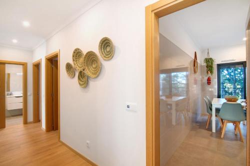 a hallway with a dining room and a dining table at Apartamento Beira Mar - 1º Direito in Tavira