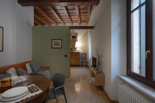 a living room with a table and a dining room at Residenza Roccamaggiore in Verona