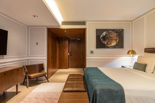 a bedroom with a bed and a desk at L'Hotel PortoBay São Paulo in Sao Paulo