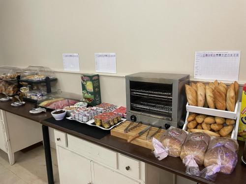 a counter with bread and other food on it at Hotel Ciudad de Navalcarnero in Navalcarnero