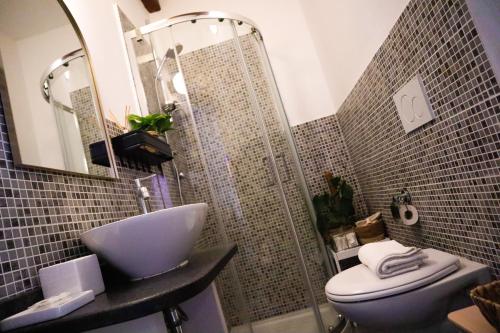 a bathroom with a toilet and a sink and a mirror at Guest House Camilla in Alghero