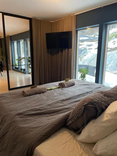 - un grand lit dans une chambre avec un grand miroir dans l'établissement Orrvägen, à Torshälla