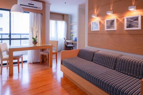 a living room with a couch and a table at eSuítes Congonhas by Atlantica in Sao Paulo
