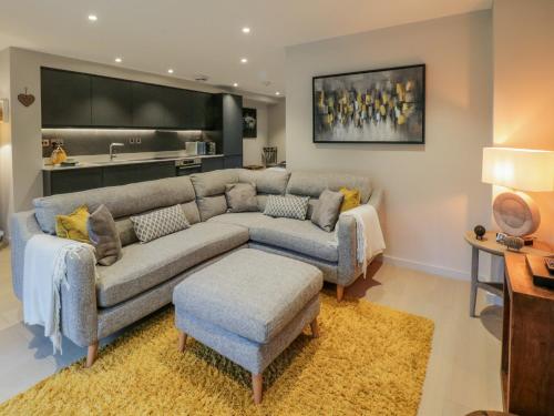 a living room with a couch and a tv at Rivers Edge in Ulverston