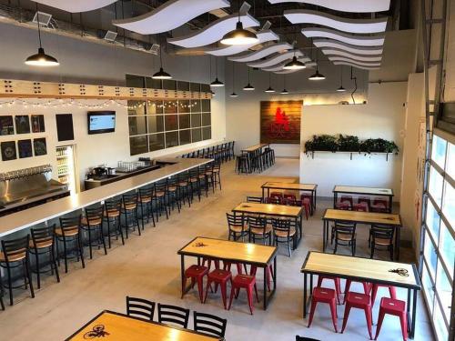 an empty restaurant with wooden tables and chairs at Modern & Quant KOP 3 Bed/1 ba in King of Prussia