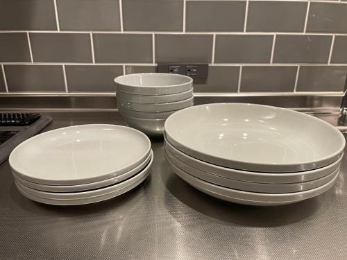 two stacks of white plates sitting on a kitchen counter at Hotel Yuzuki in Takamatsu