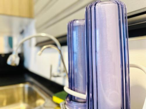 a purple blender sitting on top of a kitchen counter at Cozy & Drive Urban Suite by WL in Jelutong