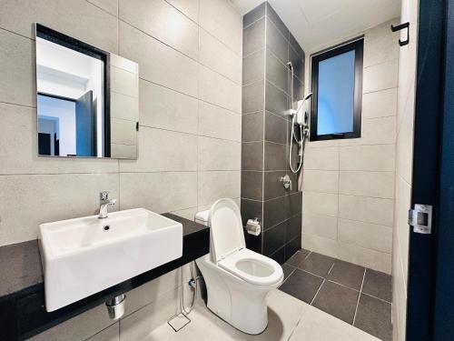 a bathroom with a toilet and a sink at Cozy & Drive Urban Suite by WL in Jelutong