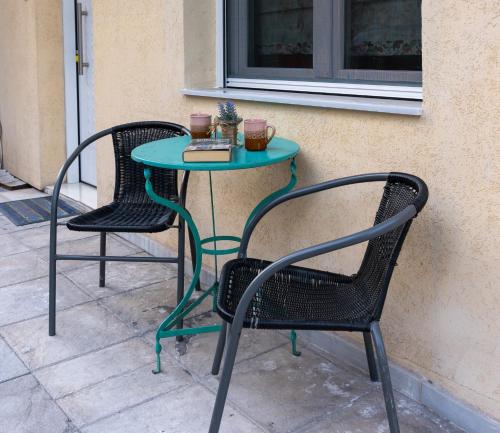 a table with two chairs and a table with a book at Dream House in Xanthi