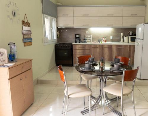 a kitchen with a table and chairs in a kitchen at Dream House in Xanthi