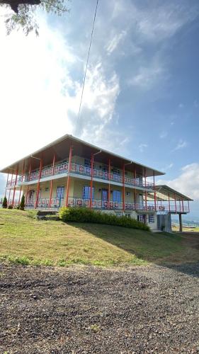 a large building on the beach with the ocean behind it at Villa Jair Hotel in Filandia