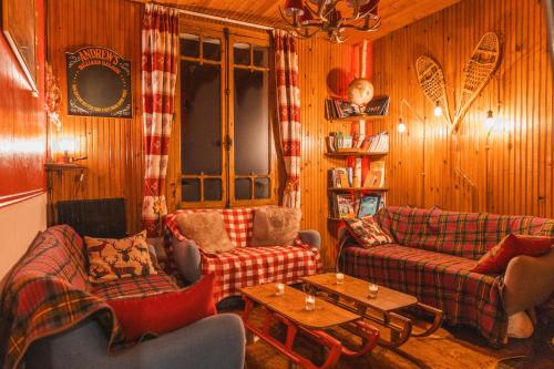 a living room with two couches and a table at Les Ruisseaux in Cauterets