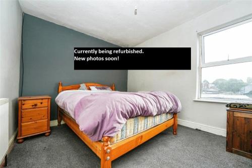 a bedroom with a bed and a window at 3 bed house in Gloucester near to city centre 