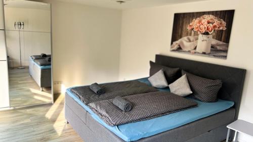 a bed in a room with a vase of flowers on it at Ferienhaus Wachwitzgrund in Dresden