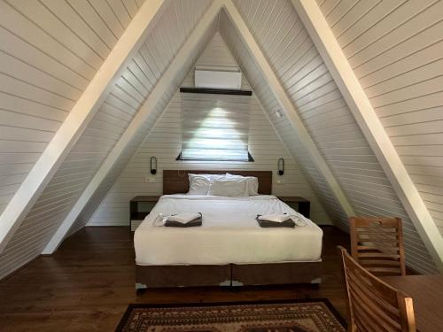 a bedroom with a bed in an attic at Guzel Evler Family Resort in Sapanca
